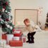 winter holidays decorations warm colors beautiful little girl plays with present boxes 68x68 - Moda infantil para o Fim de Ano: As melhores dicas para as pequenas
