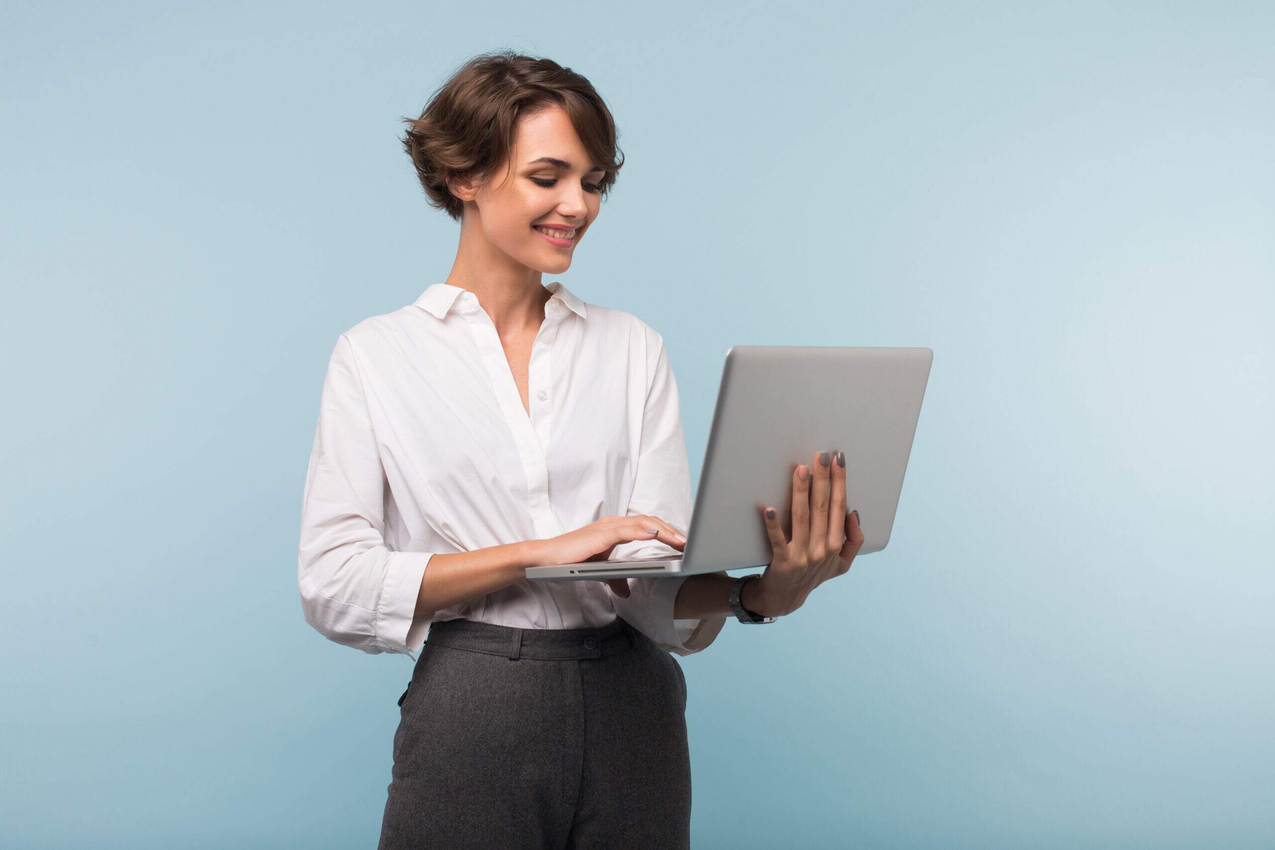 Young pretty smiling businesswoman with dark short hair in white